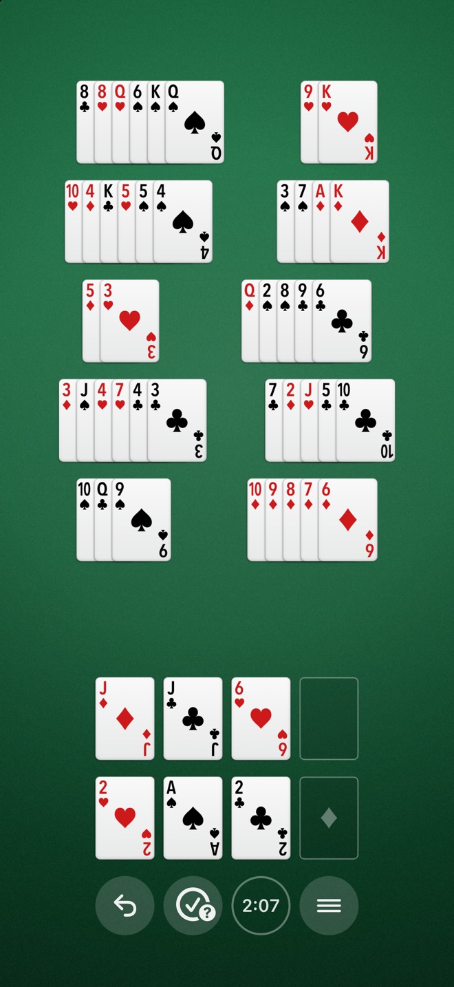 A game of Breakaway in progress: stacks of cards fanned across a green table, a run of diamonds broken away into a stack of its own, three cards in the free cells, and cards home on their foundations