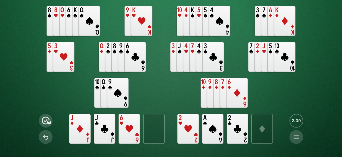 The same game on an iPhone turned sideways: the stacks in rows across the screen, the free cells and foundations in one row beneath them, and the buttons at either side